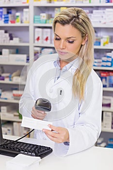 Pharmacist scanning medicines