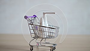 The pharmacist in the seals fills a mini shopping cart with various medicines for a viral respiratory illness. Medicine