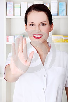 Pharmacist showing stop gesture.