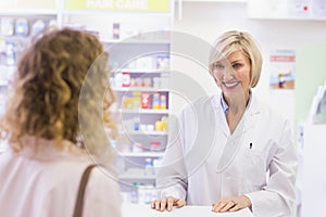 Pharmacist smiling at costumer photo