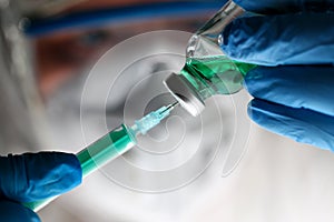 Pharmacist Syringe Dosing Green Liquid Vaccine