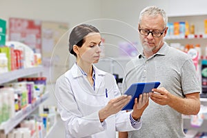 Pharmacist with tablet pc and senior man