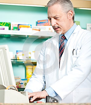 Pharmacist typing at cmoputer