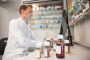 Pharmacist using computer at desk