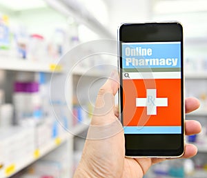 Pharmacist using mobile smart phone in pharmacy