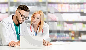 Pharmacist working with computer in pharmacy.