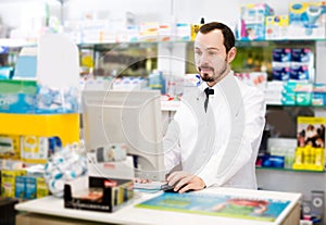 Pharmacist writing down assortment of drugs
