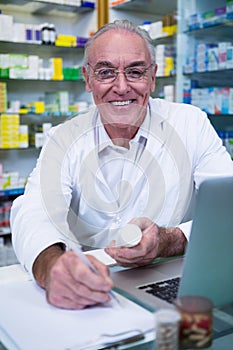 Pharmacist writing prescriptions for medicines
