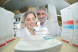 pharmacists checking medicines on shelf in pharmacy