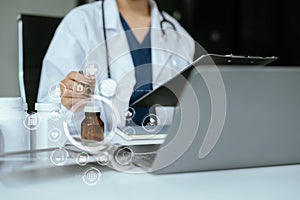 Pharmacists or doctors study information about tablets in the operating room