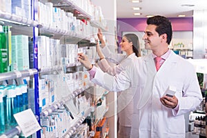Pharmacists posing in drugstore