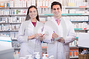 Pharmacists posing in drugstore