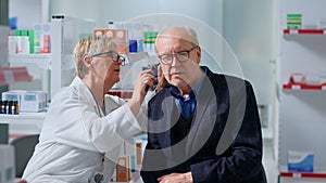 Pharmacologist doing annual ear exam