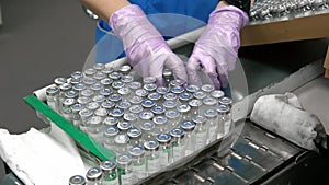 Pharmacologist putting drugs in bottles into box.