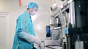 Pharmacologist is sorting capsule pills in the factory unit