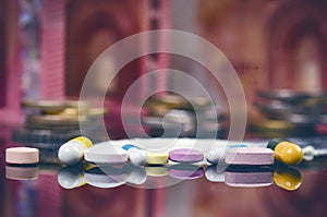 Pharmacy background on a black table with reflection. Euro banknote such as background. Pills. Medicine and healthy. Close up of c