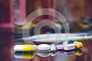 Pharmacy background on a black table with reflection. Euro banknote such as background. Pills. Medicine and healthy. Close up of c