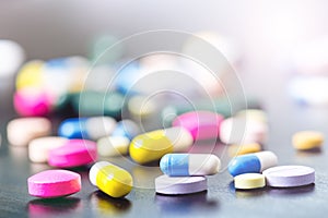 Pharmacy background on a black table. Tablets on a black background. Pills. Medicine and healthy. Close up of capsules. Differend