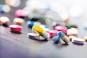 Pharmacy background on a black table. Tablets on a black background. Pills. Medicine and healthy. Close up of capsules. Differend