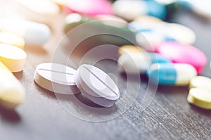 Pharmacy background on a black table. Tablets on a black background. Pills. Medicine and healthy. Close up of capsules. Differend