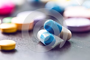 Pharmacy background on a black table. Tablets on a black background. Pills. Medicine and healthy. Close up of capsules. Differend