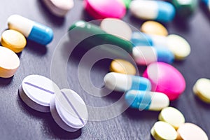 Pharmacy background on a black table. Tablets on a black background. Pills. Medicine and healthy. Close up of capsules. Differend