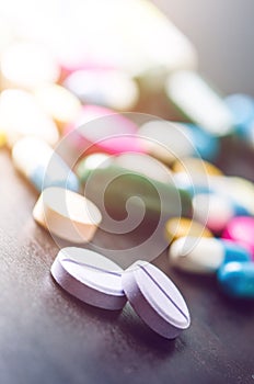 Pharmacy background on a black table. Tablets on a black background. Pills. Medicine and healthy. Close up of capsules. Differend