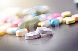 Pharmacy background on a black table. Tablets on a black background. Pills. Medicine and healthy. Close up of capsules. Differend