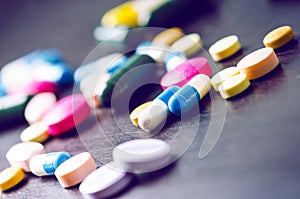 Pharmacy background on a black table. Tablets on a black background. Pills. Medicine and healthy. Close up of capsules. Differend