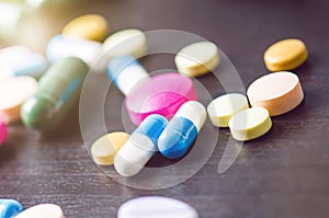 Pharmacy background on a black table. Tablets on a black background. Pills. Medicine and healthy. Close up of capsules. Differend