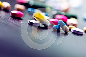 Pharmacy background on a black table. Tablets on a black background. Pills. Medicine and healthy. Close up of capsules. Differend