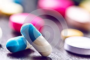 Pharmacy background on a black table. Tablets on a black background. Pills. Medicine and healthy. Close up of capsules. Differend