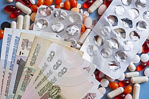 Pharmacy background. Business finance. Russian money and pills on blue backgrouind.