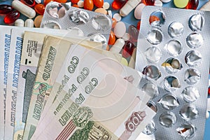 Pharmacy background. Business finance. Russian money and pills on blue backgrouind.