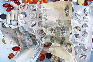 Pharmacy background. Business finance. Russian money and pills on blue backgrouind.