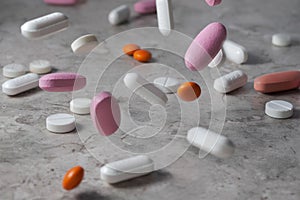 Pharmacy background on a dark table. Levitation pills. Tablets on a dark background which falling down. Pills. Medicine and