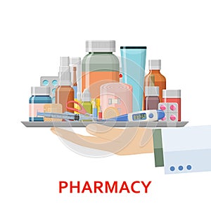 Pharmacy background. Different medical pills, plaster, thermometer, syringe and bottles in doctor hand.