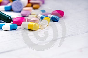 Pharmacy background on a white table. Tablets on a white background. Pills. Medicine and healthy. Close up of capsules. Differend