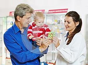 Pharmacy chemist, father and baby in drugstore