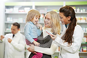 Pharmacy chemist, mother and child in drugstore