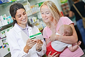 Pharmacy chemist with mother and child in drugstore
