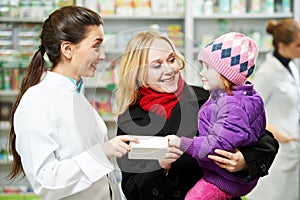 Pharmacy chemist, mother and child in drugstore