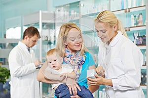 Pharmacy chemist, mother and child in drugstore