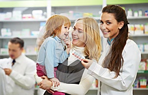 Pharmacy chemist, mother and child in drugstore photo