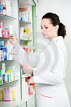 Pharmacy chemist woman in drugstore photo