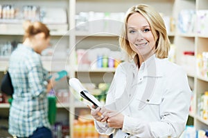 Pharmacy chemist woman in drugstore photo