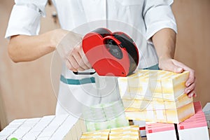 Pharmacy chemist woman labeling drugs photo