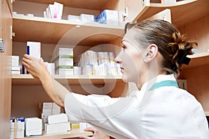 Pharmacy chemist woman labeling drugs