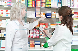 Pharmacy chemist women in drugstore photo