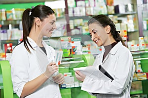 Pharmacy chemist women in drugstore photo